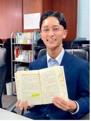 後輩へ進呈した参考書を手にする栗山和也さん
