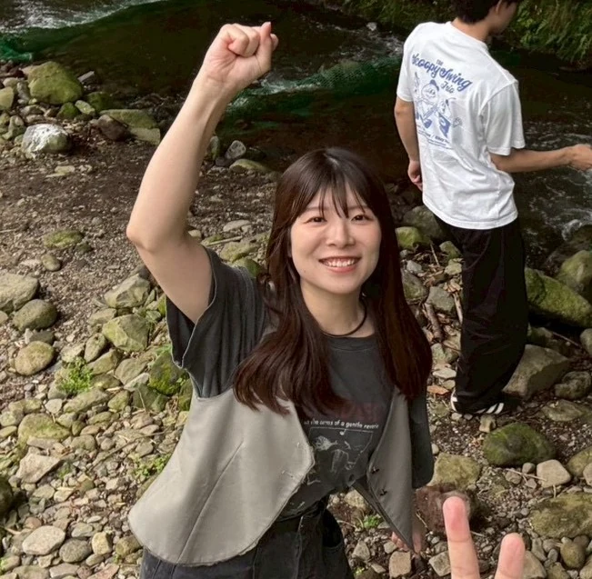 自然の中で笑顔を見せる高橋萌香さん
